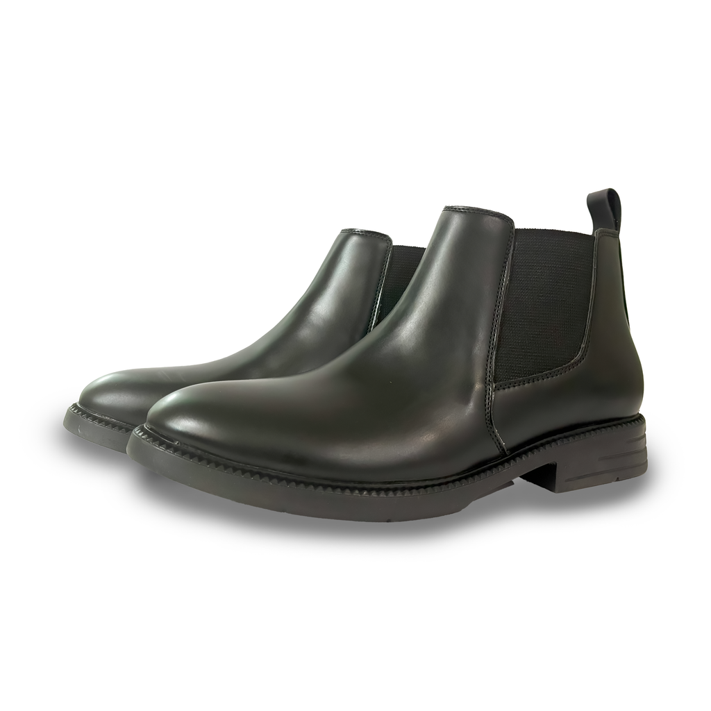 Pair of blqckChelsea boots on a white background