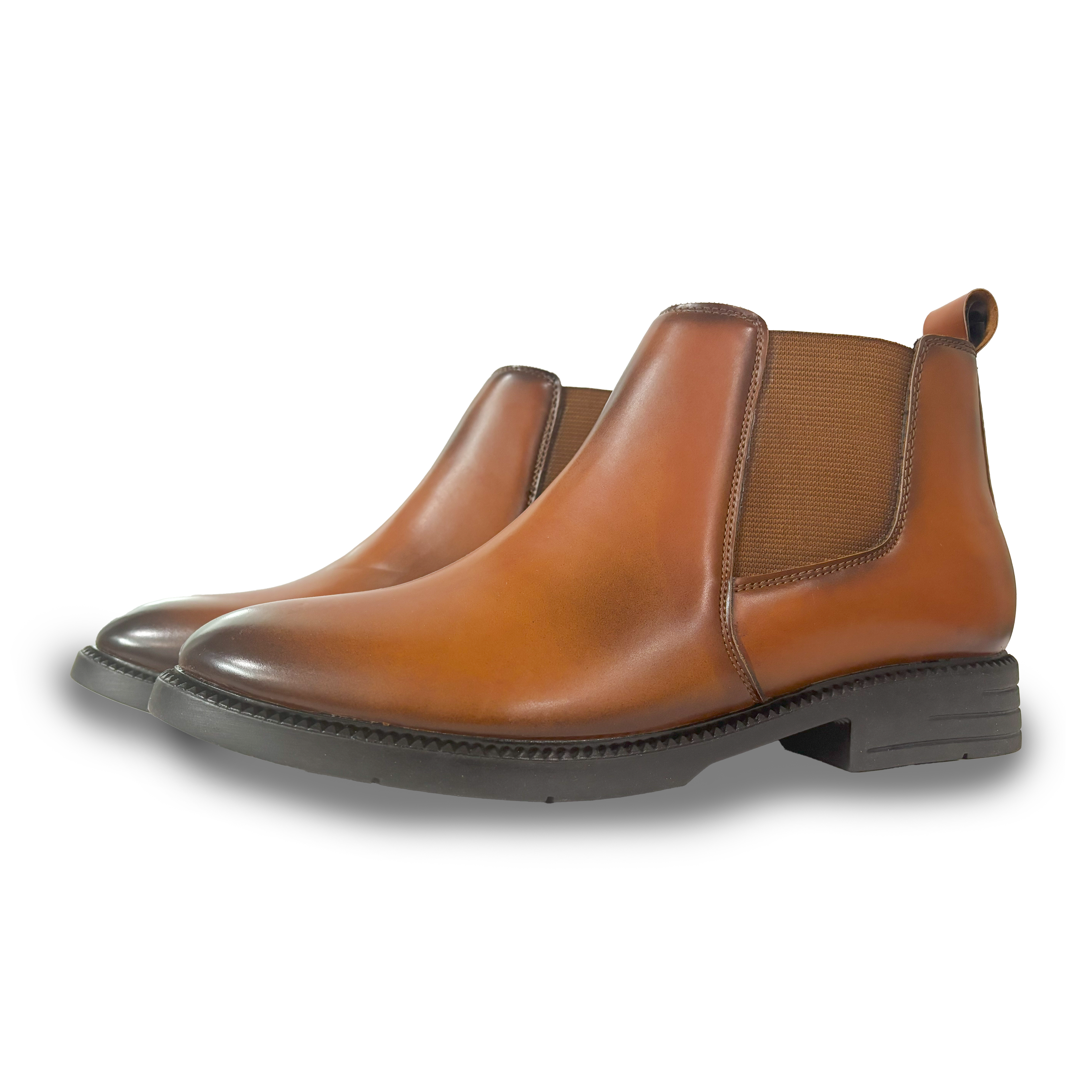 Pair of brown leather Chelsea boots on a white background